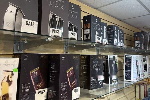 Clipper and trimmer wall at Beauty Time — Andis Fade Master, Wahl Shaver Shaper and Wahl Senior boxes on glass shelves.